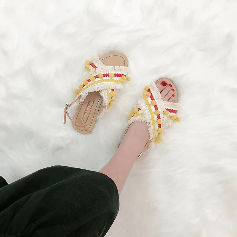 BOOPDO DESIGN CROSS OVER FLAT SANDALS WITH TASSEL AND POM POM DETAIL